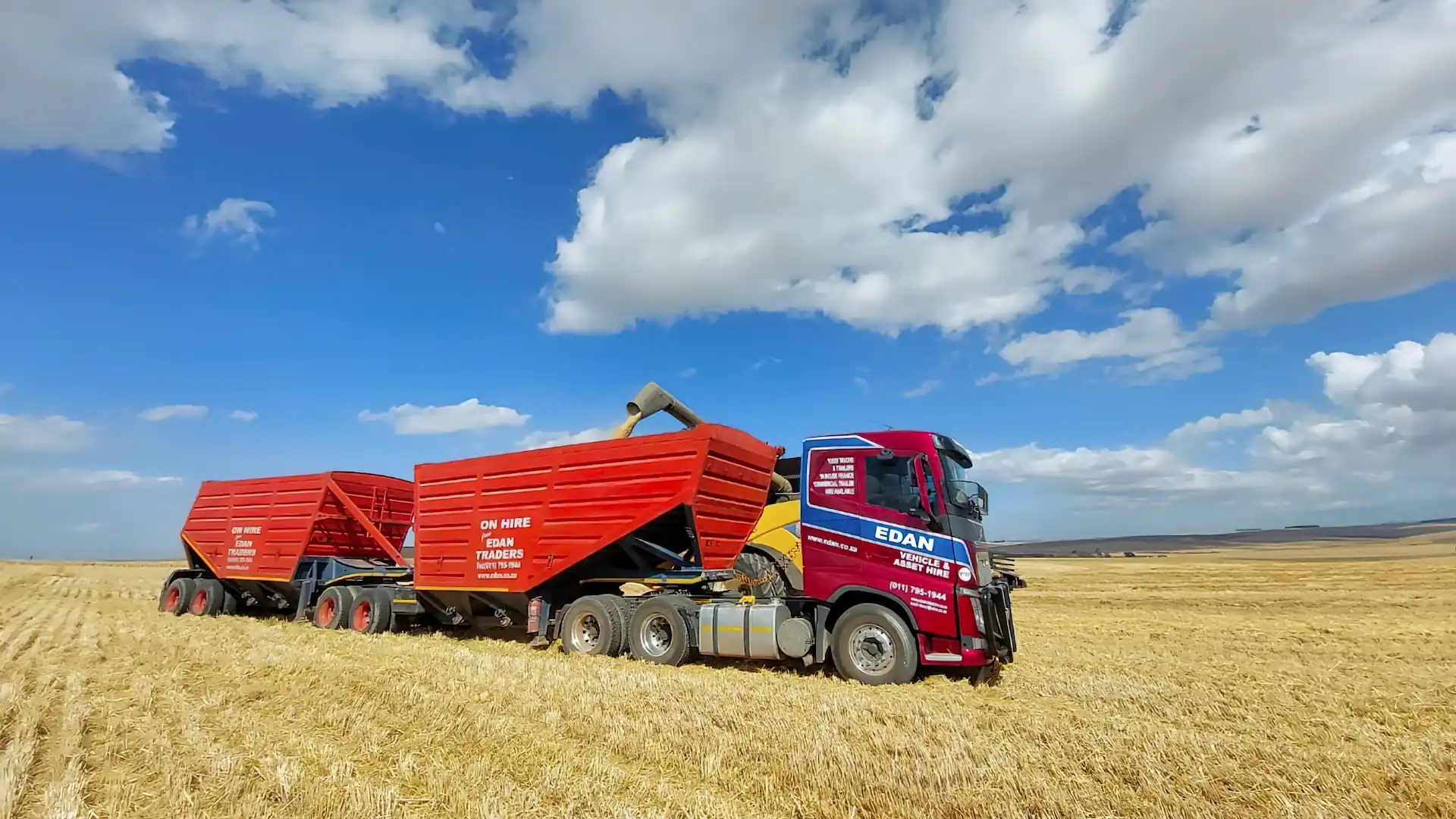 Edan Vehicle & Asset Hire truck with interlink bottom dumper trailers during grain harvesting in South Africa.
