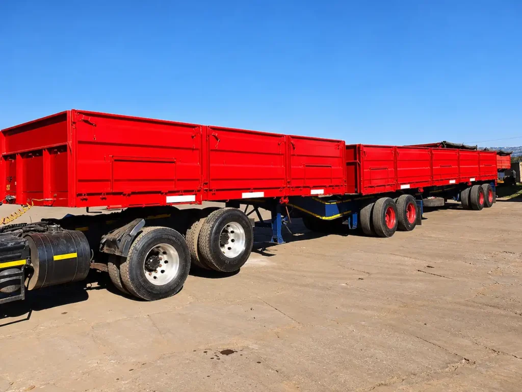 Red high-sided dropside Superlink trailers for hire from Edan Vehicle & Asset Hire.