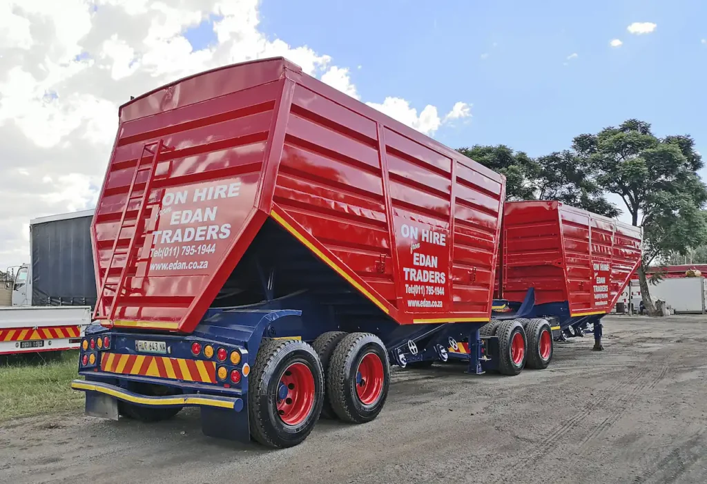 Red interlink bottom dumper trailers available for hire from Edan Vehicle & Asset Hire, viewed from the rear.