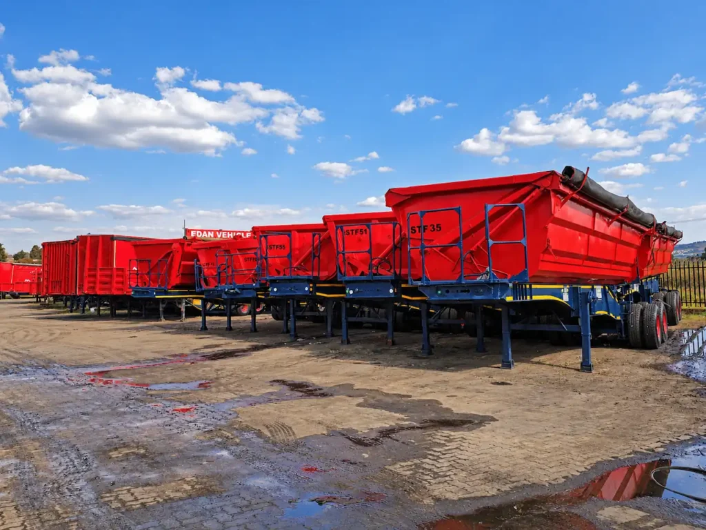 Fleet of red interlink side tipper trailers available for hire from Edan Vehicle and Asset Hire.