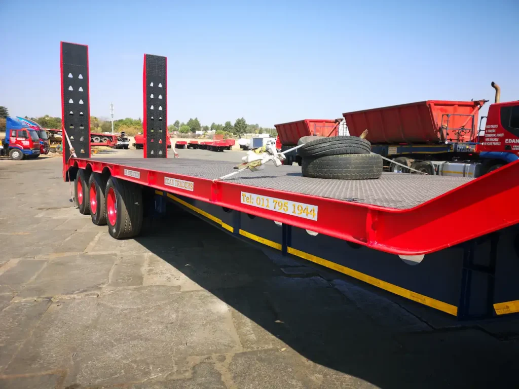 Lowbed trailer for hire in South Africa with raised rear loading ramps, suitable for transporting heavy machinery, construction equipment and industrial vehicles.