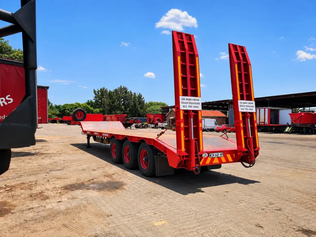 lowbed trailer with raised loading ramps available for hire from Edan Vehicle & Asset Hire for heavy machinery and equipment transport.