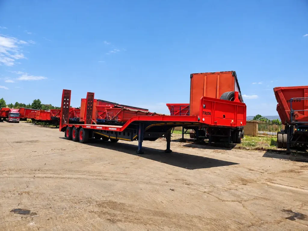 Stepdeck lowbed trailer with raised loading ramps available for hire from Edan Vehicle & Asset Hire for transporting heavy equipment and machinery.
