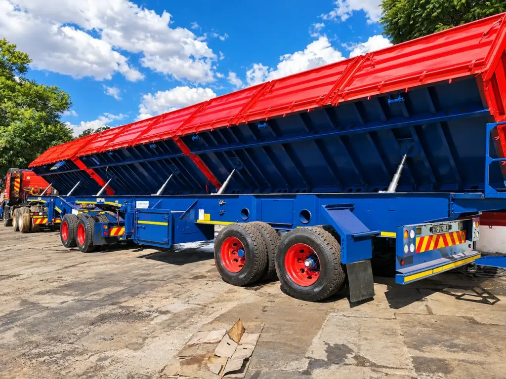 Superlink dropside tipper trailer with its bin raised, showing the hydraulic tipping mechanism.