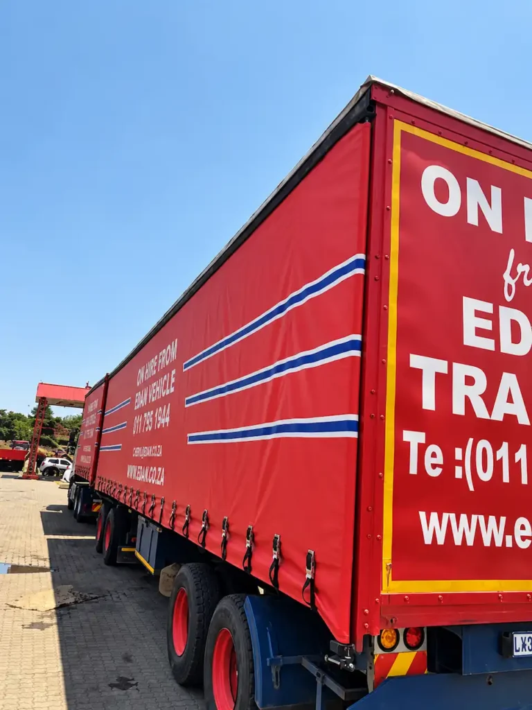 Red tautliner trailer for hire in South Africa, showing the curtain-sided body and rear frame.