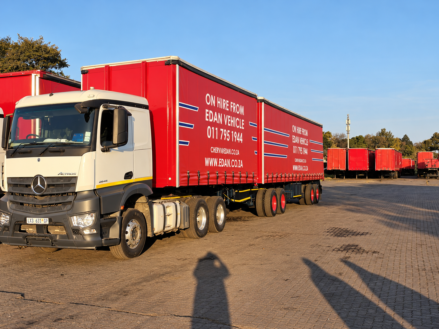 White Mercedes-Benz Actros truck with red tautliner trailers available for hire from Edan Vehicle & Asset Hire.