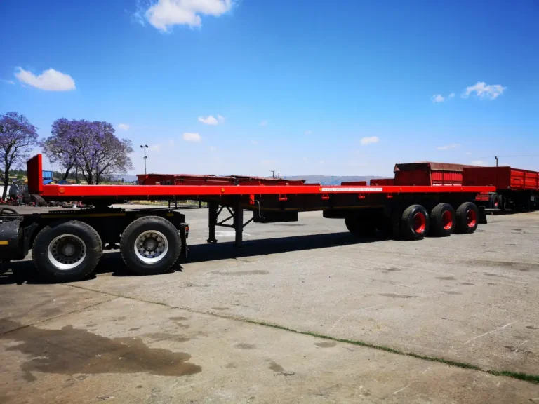 Tri-axle flat deck trailer for hire from Edan Vehicle & Asset Hire in South Africa, suitable for transporting heavy freight, machinery, building materials and general cargo.