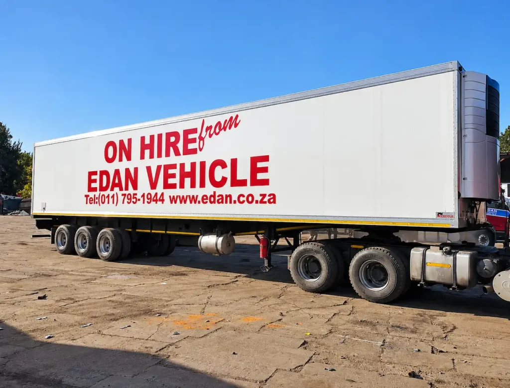 Triaxle fridge trailer for hire from Edan Vehicle & Asset Hire, featuring a white refrigerated body and multiple axles.
